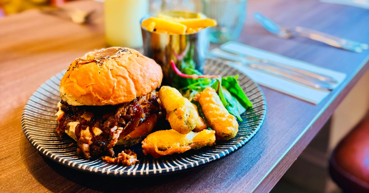 Burger with battered pickles and chips from the kitchen at The Fox at Walton